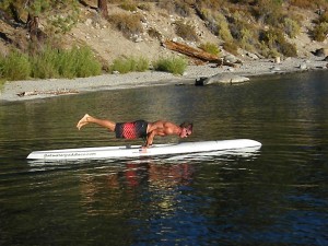 Scott Boyle performs the plank on an SUP